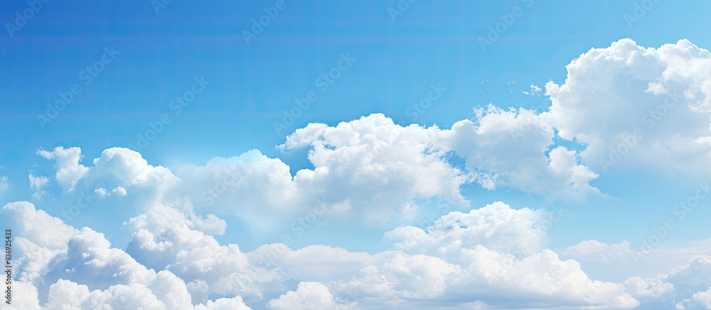 Poster blue sky with fluffy white clouds on a sunny day, creating a serene atmosphere for a copy space imag