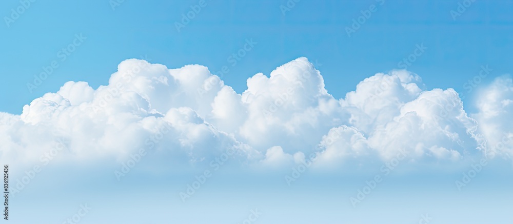 Poster cloud floating in a clear blue sky, providing a serene backdrop for copy space image.