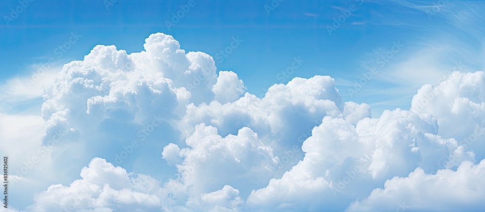 Poster Cloudy weather with cumulus clouds creates an abstract backdrop suitable for design projects with copy space image.