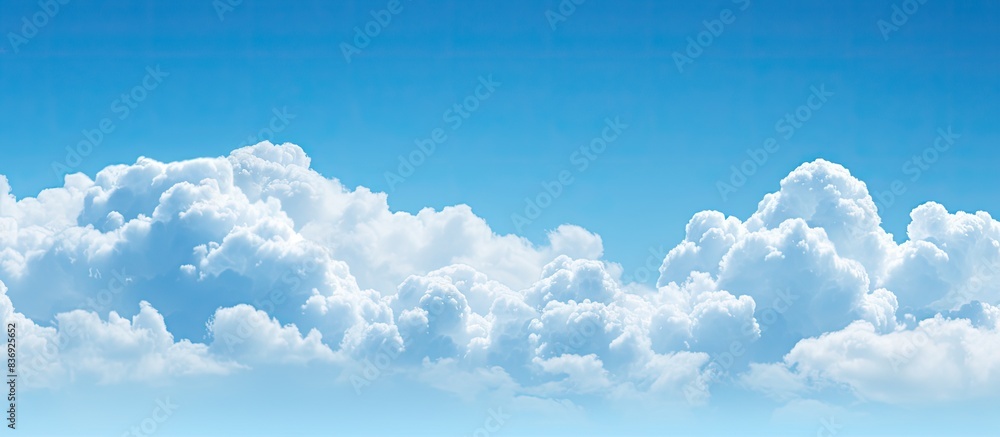 Poster Cloud floating in a clear blue sky, providing a serene backdrop for copy space image.