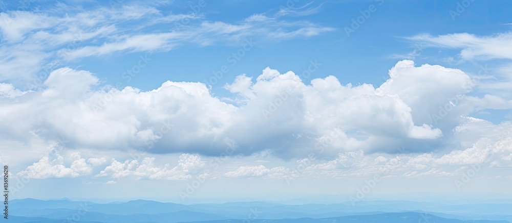 Poster daytime scenery with a mix of blue sky and overcast gray clouds, featuring a vast copy space image.