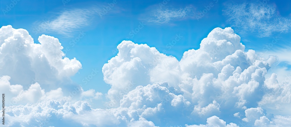 Aufkleber the blue sky with fluffy white clouds provides a serene backdrop for the copy space image.