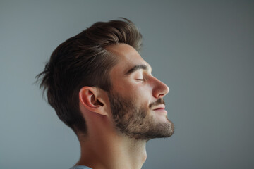 Fototapeta premium A close up of a man with beard and closed eyes looking to a side