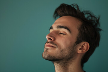Fototapeta premium A close up of a man with beard and closed eyes looking to a side