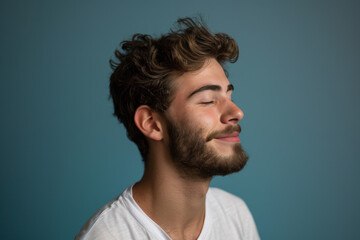 Fototapeta premium A close up of a man with beard and closed eyes looking to a side