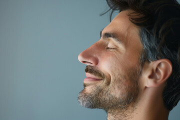 Fototapeta premium A close up of a man with beard and closed eyes looking to a side