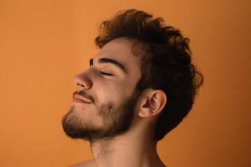 Fototapeta premium A close up of a man with beard and closed eyes looking to a side