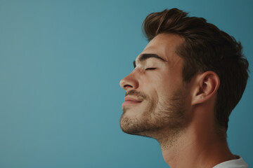 Fototapeta premium A close up of a man with beard and closed eyes looking to a side