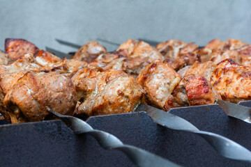 Fresh appetizing pieces of kebab meat are grilled