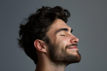 Fototapeta premium A close up of a man with beard and closed eyes looking to a side