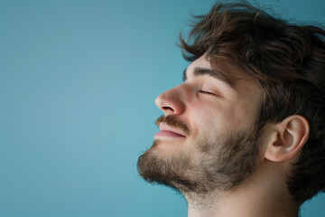 Fototapeta premium A close up of a man with beard and closed eyes looking to a side