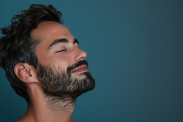 Fototapeta premium A close up of a man with beard and closed eyes looking to a side