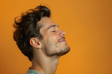 Fototapeta premium A close up of a man with beard and closed eyes looking to a side