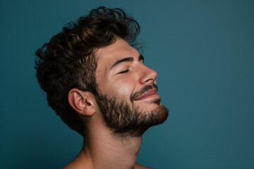 Fototapeta premium A close up of a man with beard and closed eyes looking to a side