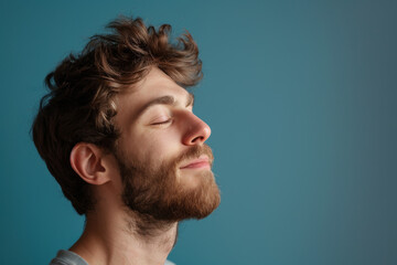 Fototapeta premium A close up of a man with beard and closed eyes looking to a side