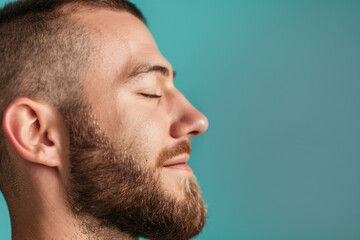 Fototapeta premium A close up of a man with beard and closed eyes looking to a side