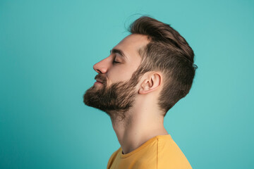 Obraz premium A close up of a man with beard and closed eyes looking to a side