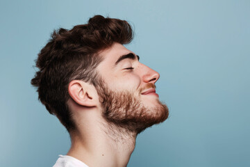 Obraz premium A close up of a man with beard and closed eyes looking to a side