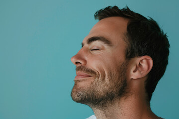 Fototapeta premium A close up of a man with beard and closed eyes looking to a side