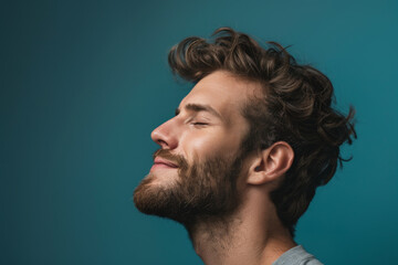Fototapeta premium A close up of a man with beard and closed eyes looking to a side