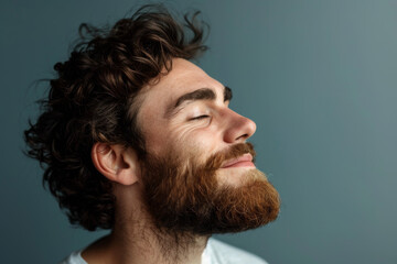 Fototapeta premium A close up of a man with beard and closed eyes looking to a side