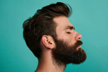Fototapeta premium A close up of a man with beard and closed eyes looking to a side