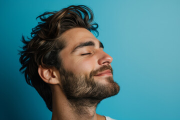 Fototapeta premium A close up of a man with beard and closed eyes looking to a side