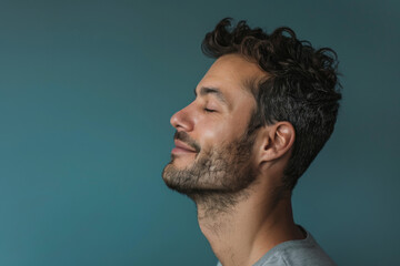 Obraz premium A close up of a man with beard and closed eyes looking to a side