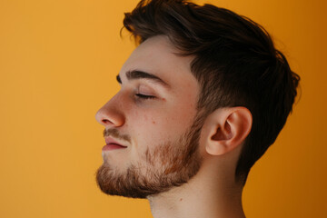Fototapeta premium A close up of a man with beard and closed eyes looking to a side