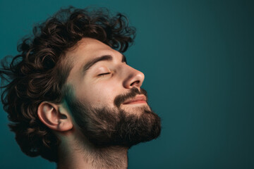 Fototapeta premium A close up of a man with beard and closed eyes looking to a side