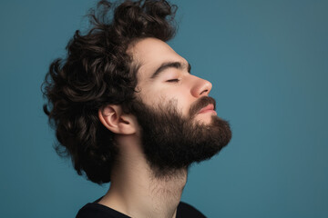 Fototapeta premium A close up of a man with beard and closed eyes looking to a side