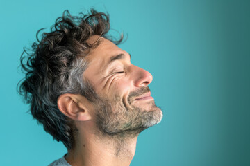 Fototapeta premium A close up of a man with beard and closed eyes looking to a side