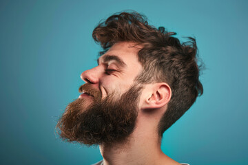 Obraz premium A close up of a man with beard and closed eyes looking to a side