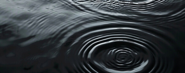 Black Water surface with gentle ripples and concentric rings, capturing the serene and refreshing essence of calm water