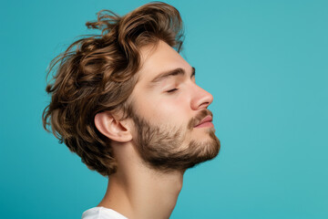 Obraz premium A close up of a man with beard and closed eyes looking to a side