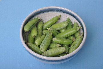 peas in a bowl on a blue background