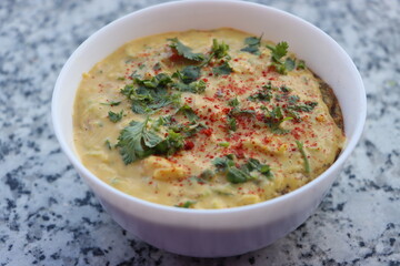 Pithale, pithal pithala or  a chickpea flour porridge, a vegetarian traditional Indian dish prepared in Maharashtra