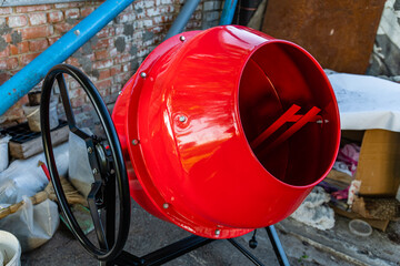 Red concrete mixer. Construction machinery. Construction site
