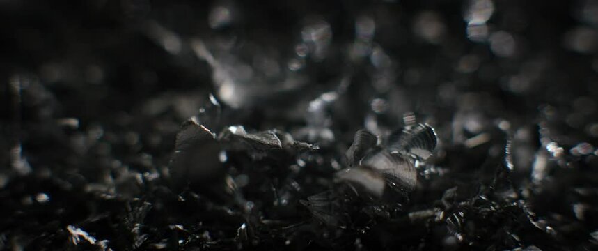 Silver metal raspings move chaotically and glitter
