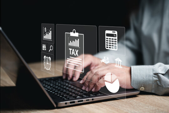 Tax payment electronic documents, tax calculations online software, Businessman input tax data online on laptops, Individual income tax return Government, and state taxes. Refunds, Data analysis