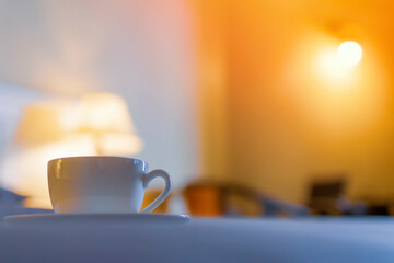 Coffee cup on a table in a dimly lit room
