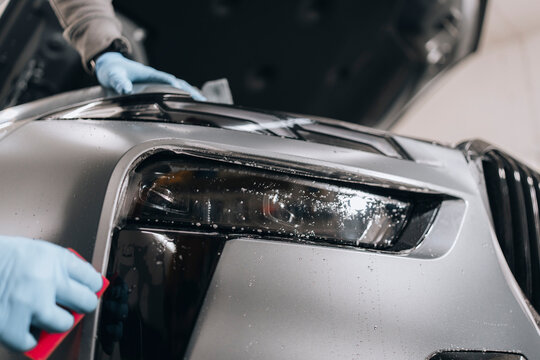 Photo of BMW X7 G07. The photo shows the application of ppf foil. Complementary work in the detailing studio with wrapping