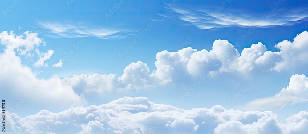 Aufkleber White soft clouds floating gracefully in the clear blue sky, creating a serene backdrop suitable for a copy space image.