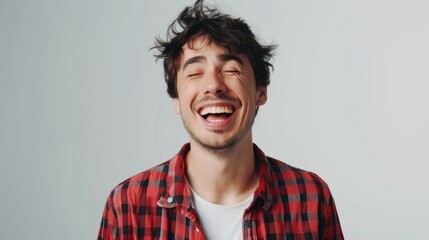 Obraz premium A smiling man wearing a bold red and black plaid shirt
