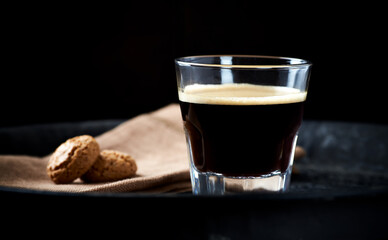 Coffee in glass cup on dark background. Close up. Copy space