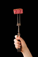 Slices of plant based vegan meat steak on meat fork. Alternatives meat. Eco friendly healthy food,