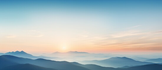 Obraz premium Beautiful sunset behind the mountains with a beautiful blue sky. Creative banner. Copyspace image