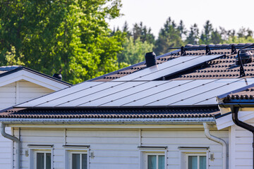 Close-up perspective of a villa roof integrating advanced solar panel technology within a village...