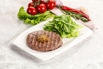 Frilled beef burger cutlet with iceberg