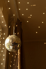 Disco Ball Reflecting Light On Ceiling In Interior Room. Sunlight. Home interior